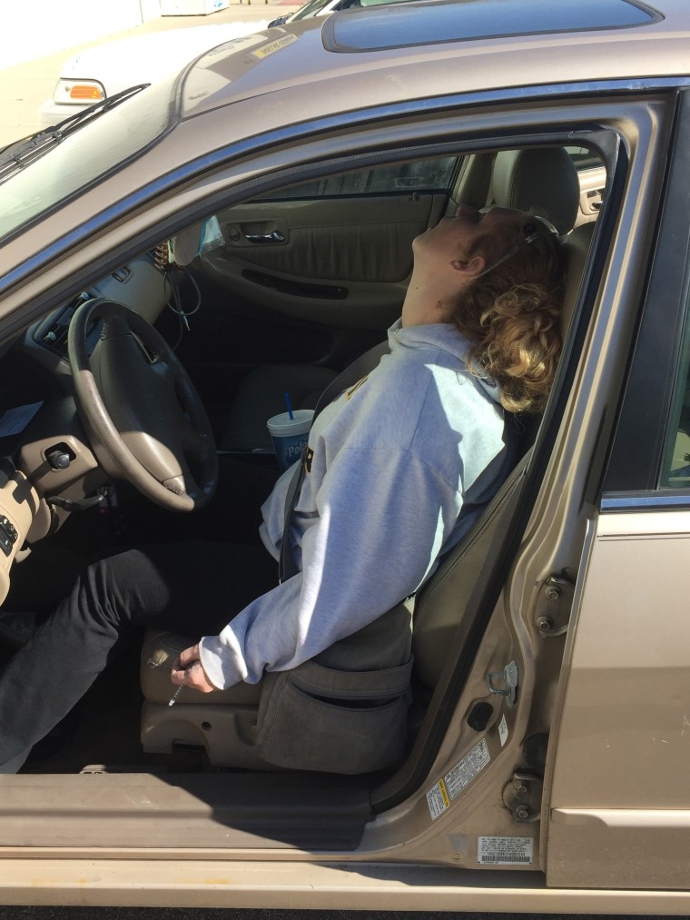 Image: Erika Hurt sits with her baby in the back seat of the car in Hope, Indiana. Police said she appeared unresponsive from an overdose and had a syringe in her hand.