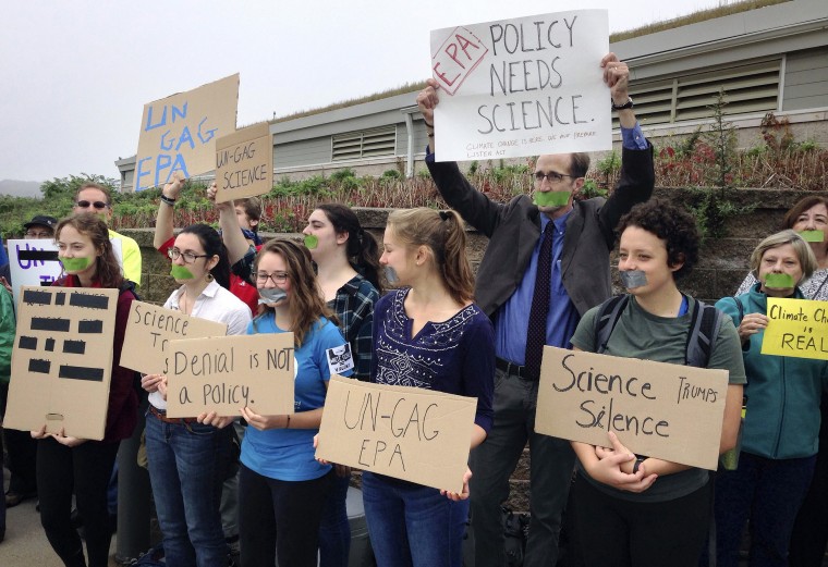 Image: Protesters gather outside a meeting where a climate change report was scheduled to be released in Providence