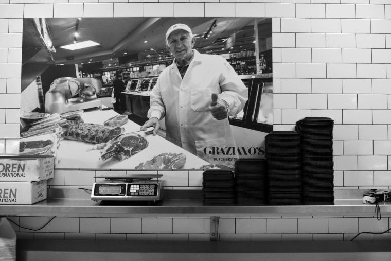 Mario Graziano in the butcher stall and market he started in Miami, now a successful culinary "empire" run by three generations.