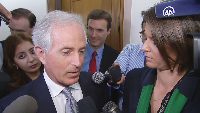 Image: Ryan Clayton of Americans Take Action stands behind Senator Bob Corker during his stakeout on Capitol Hill on Oct. 24, 2017.