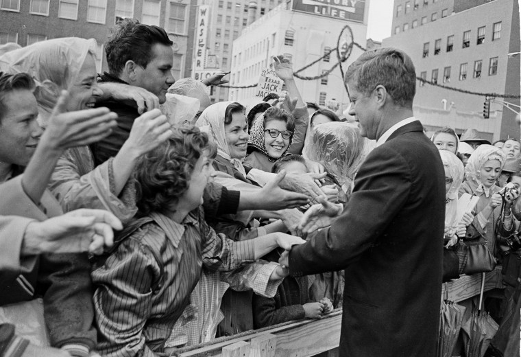 Image: President John F. Kennedy is greeted by an enthusiastic crowd in front of the Hotel Texas
