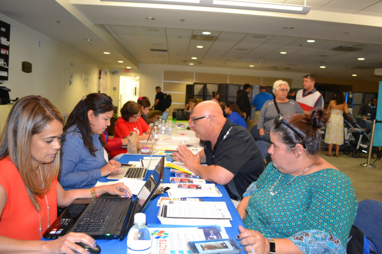 Puerto Ricans seek assistance at the hurricane relief center in Miami International Airport on October 20, 2017.