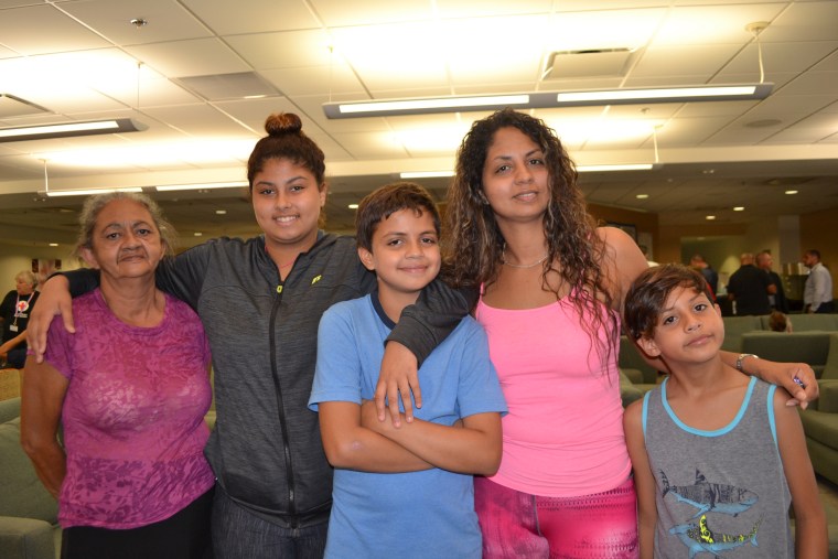 Melissa Nogueras with her mother and three children at the hurricane relief center at Miami International Airport on October, 20, 2017.