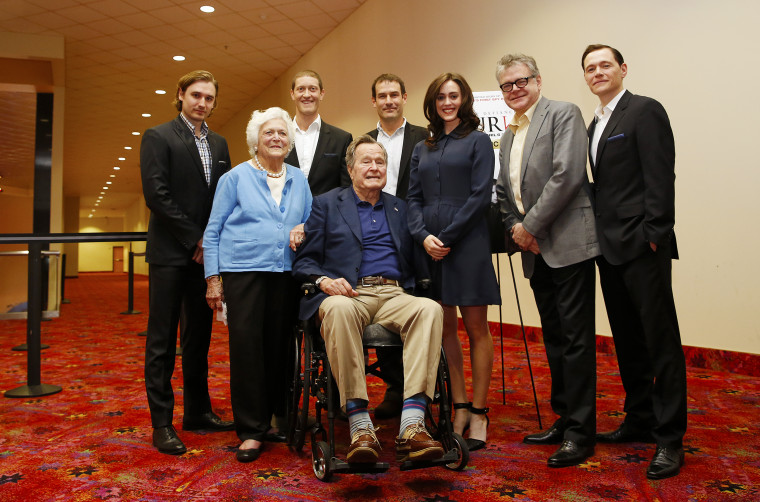 Image: Former President George H.W. Bush poses for a photo with the cast of AMC's series TURN