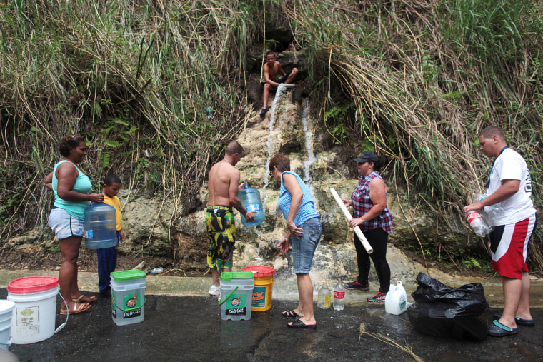 Image: People collect mountain spring water, after Hurricane Maria hit the island, in Corozal