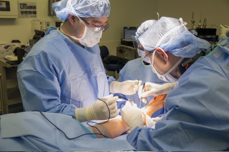 Doctors perform a joint replacement surgery at Rush University Medical Center in Chicago.