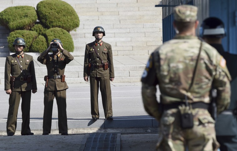 North Korean soldiers, left, look at the South side while U.S. Defense Secretary Jim Mattis visits the truce village of Panmunjom in the Demilitarized Zone on Friday.