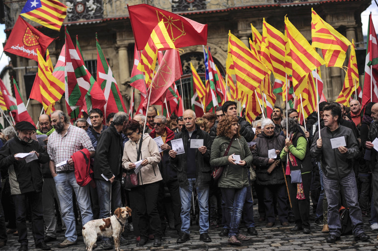 Image: Pro-independence demonstrators of Catalonia and Basque Country raise their regional flags