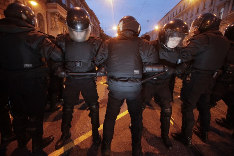 Image: Riot police officers block the way to protesters during a rally in St. Petersburg