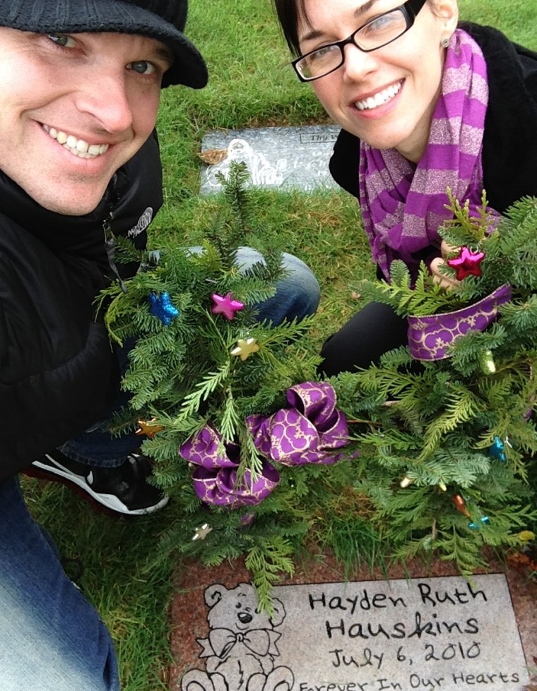 Randy and Rebekka Hauskins at the grave of their daughter, Hayden, who was stillborn in 2010.