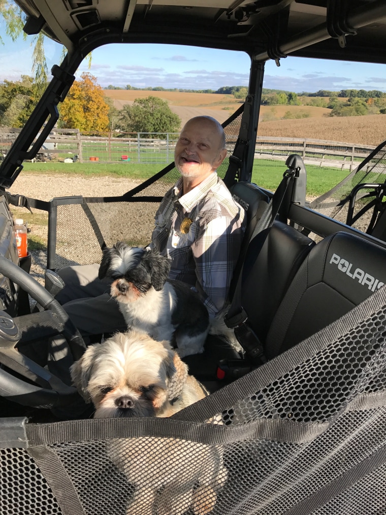 Homer Williams loves dogs but could never have one while in an institution then group home. Now he lives with two dogs and a puppy and loves giving them treats.