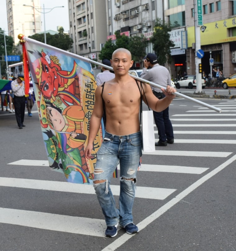 A parade-goer at Taipei's pride parade poses for a photo.