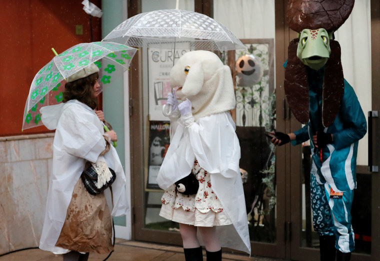 Image: Participants in costumes stand under the rain during a Halloween event in Kawasaki, Japan on Oct. 29.