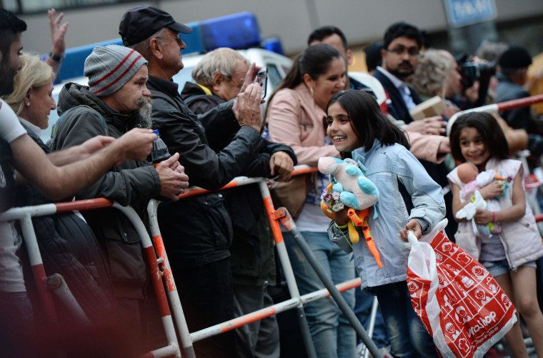 Image: Two girls smile as they arrive at the train station in Munich, Germany, on Sept. 4, 2015