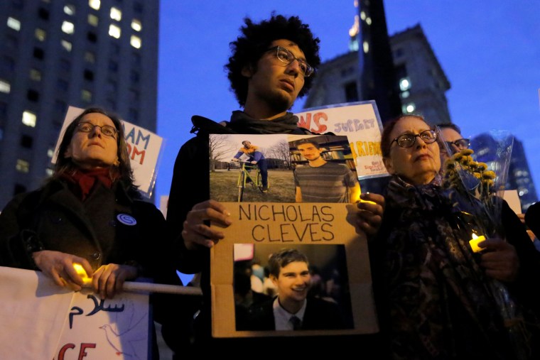 Image: Chancey stands with a sign featuring his friend and attack victim Cleves during a vigil in Foley Square in Manhattan