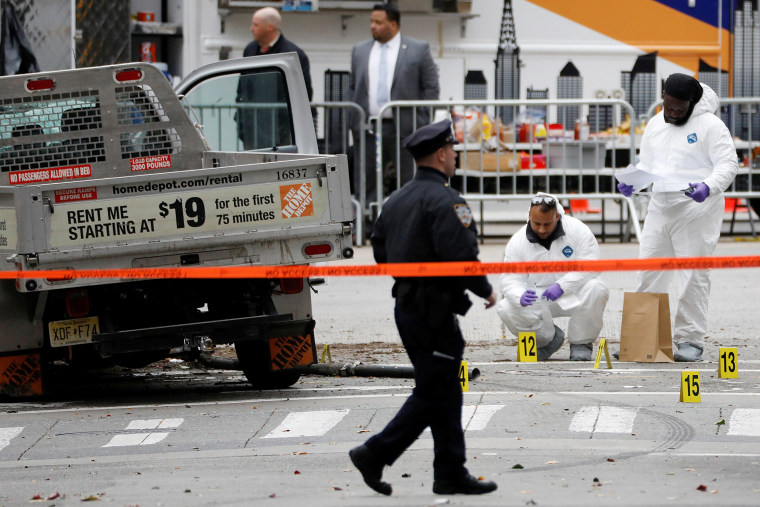 Image: Law Enforcement officials investigate a pickup truck used in an attack on the West Side Highway in lower Manhattan in New York