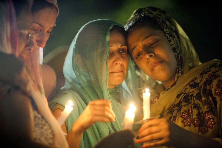 Image: Dilpreet Kaleka, left, and Simran Kaleka cry during a candlelight vigil outside of the Oak Creek Community Center in Oak Creek, Wisconsin, on Aug. 7, 2012.