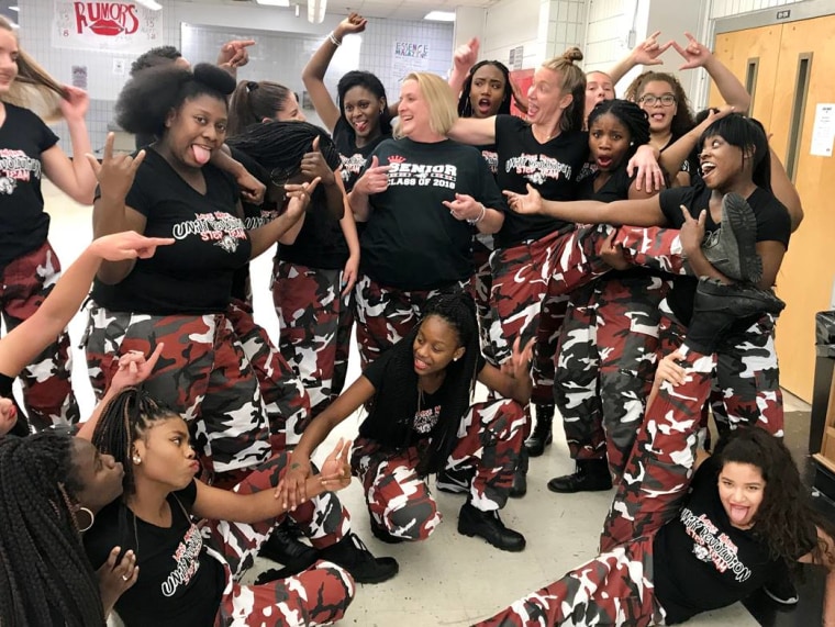 Lake Mary High School principal Dr. Mickey Reynolds poses with members of the school's step team after their surprise pep rally performance.