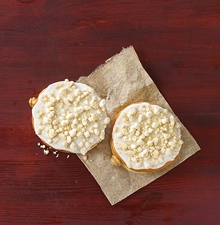 Dunkin' Donuts' Frosted Sugar Cookie Donut features a frosted yeast doughnut with cookie dough flavored filling, topped with crumbled frosted sugar cookies.