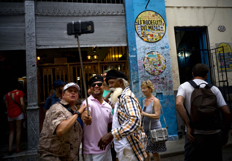 Image: Tourists take a selfie at the Bodeguita Del Medio bar in Havana