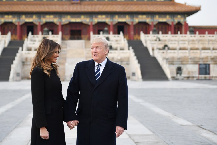 Image: US President Donald Trump holds hands with First Lady Melania Trump in the Forbidden City in Beijing