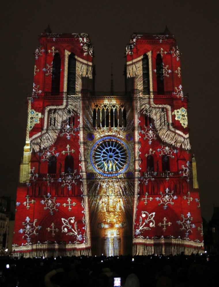 Image: The Notre Dame cathedral is illuminated during a light show called "Dame de Coeur"