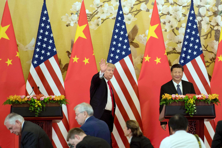 Image: President Donald Trump waves next to Chinese President Xi Jinping after delivering a joint statement