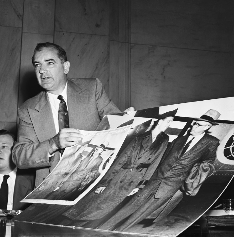 Image: Joseph McCarthy Holding Large Photographs