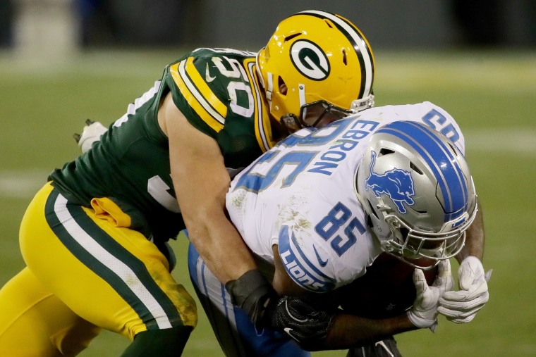 Blake Martinez #50 of the Green Bay Packers tackles Eric Ebron #85 of the Detroit Lions in the third quarter on November 6, 2017 in Green Bay, Wisconsin.