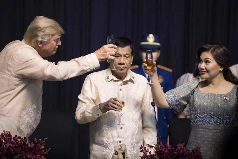 Image: Philippine President Rodrigo Duterte stands as his partner Honeylet Avancena toasts Trump during the gala dinner on Nov. 12.