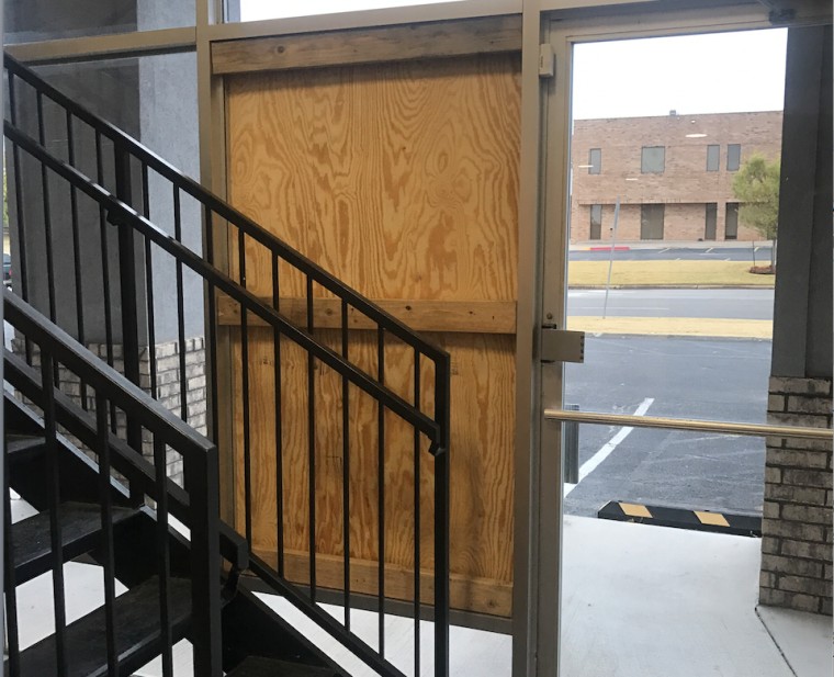 A window damaged by gunfire is boarded up in the Freedom Oklahoma building in Oklahoma City. 