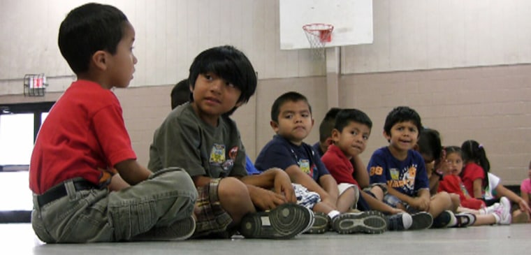In this Aug. 17, 2011 file photo, students sit in the gym at Crossville Elmentary School in Crossville, Ala.