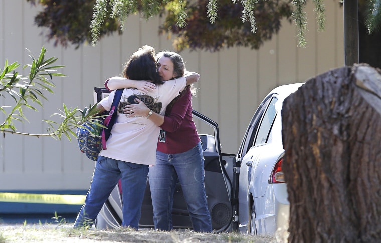 Image: Two women embrace outside Rancho Tehama Elementary School