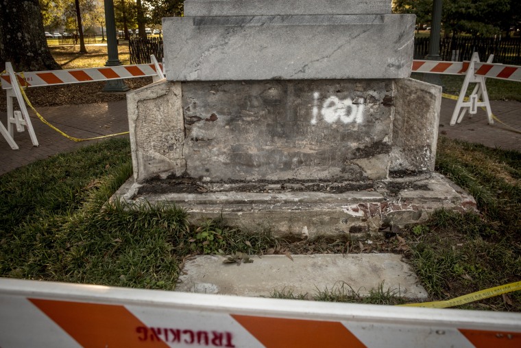 Image: Barricades surround a damaged monument to Confederate soldiers on the University of Mississippi's campus