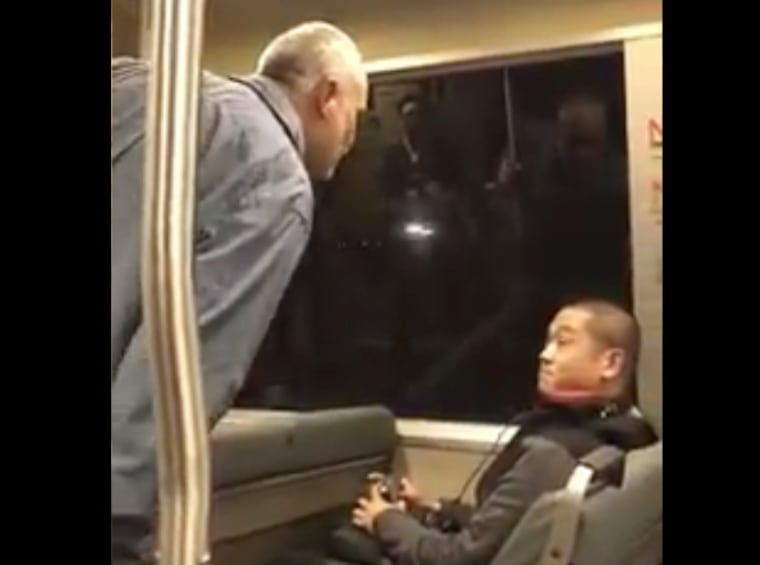 A still taken from a video showing a man harassing an apparently Asian passenger on public transportation in the San Francisco Bay Area.