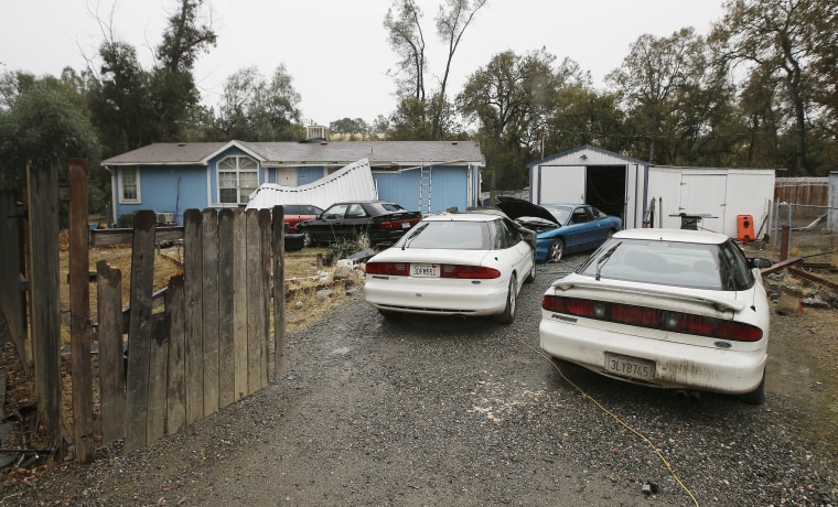 Image: Cars are parked in front of the home of Kevin Janson Neal