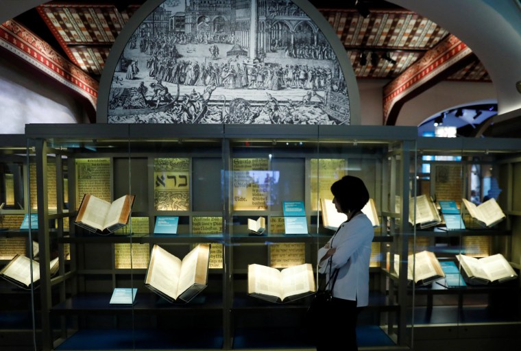 Image: A visitor looks at Bibles on display at the Museum of the Bible
