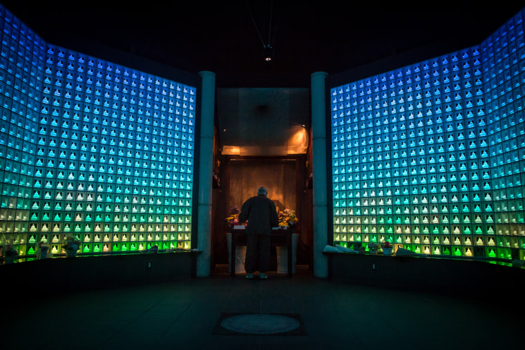 Image: Koukokuji temple head priest Yajima Taijun demonstrates a prayer ritual inside the Ruriden columbarium