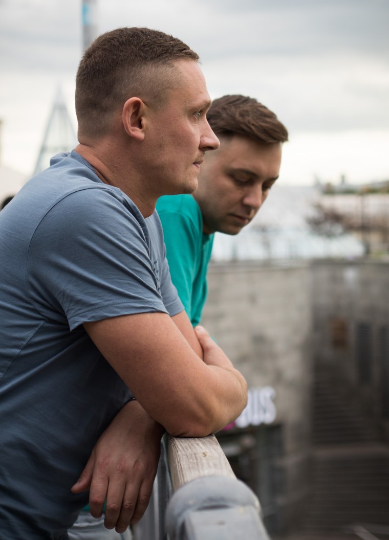 Image: Andriy Chumakov, 34, left, and his long-term boyfriend, Artem Shevchenko look onto Maidan Square