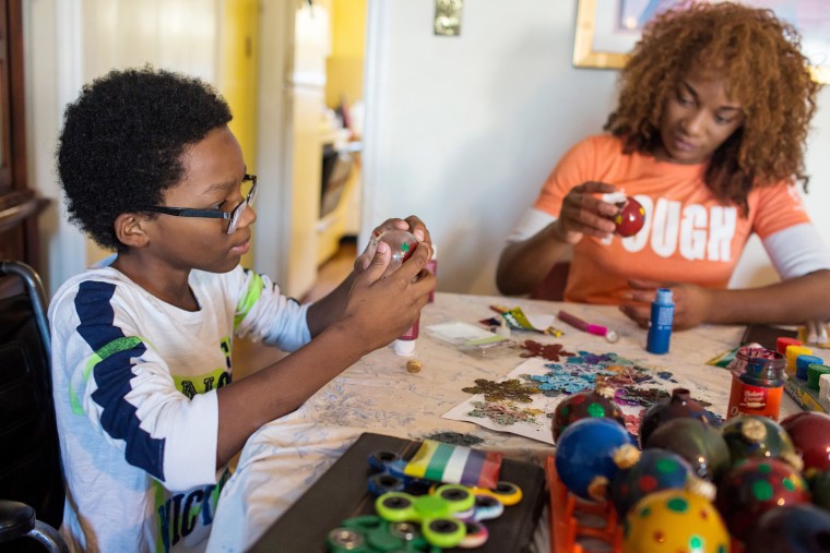 Image: Roland Williams, 11, makes Christmas ornaments with his mother
