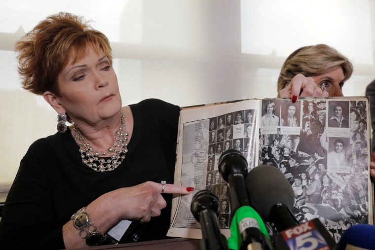 Image: Accuser Beverly Young Nelson points to a photograph of herself in her high school yearbook after making a statement claiming that Alabama senate candidate Roy Moore sexually harassed her when she was 16, in New York