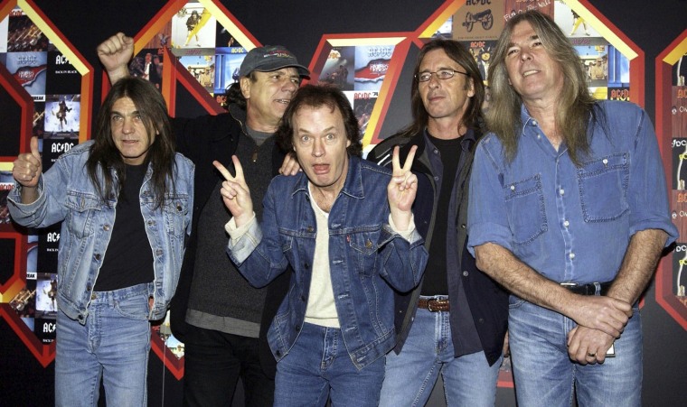 Image: Malcolm Young, Brian Johnson, Angus Young, Phil Rudd and Cliff Williams from AC/DC posing for photographers at the Apollo Hammersmith in London, March 3, 2003.