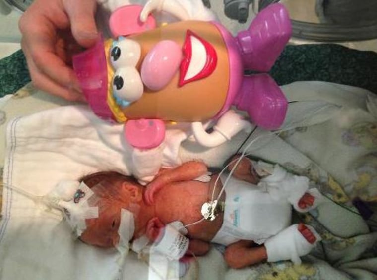 A photo of 24-week-old Dylan Moan with her Mr. Potato Head doll.