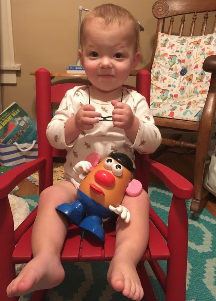 Henry Bohlman at age 17 months, posing with his Mr. Potato Head doll.
