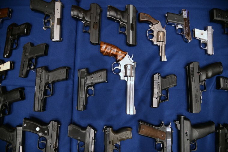 Image: A collection of seized weapons seen on display during a press conference