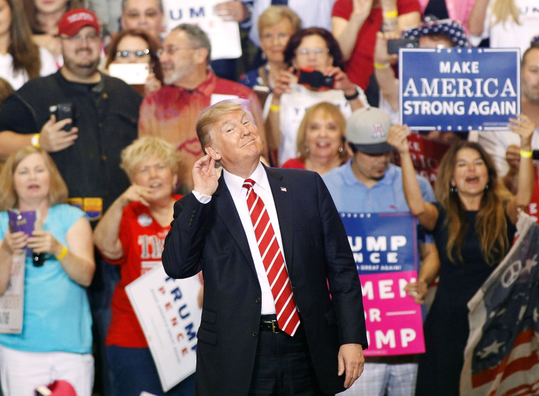 Image: Trump listens to the crowd at a rally in Phoenix