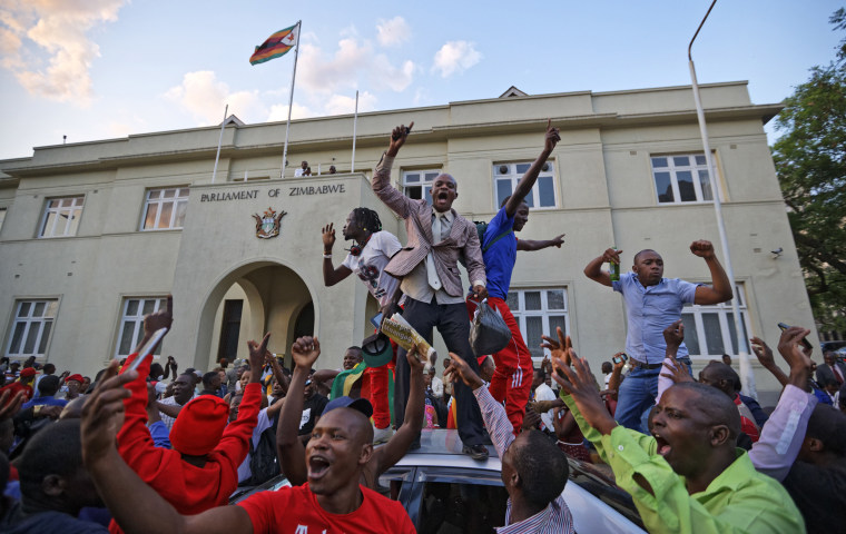 Image: Zimbabweans celebrate outside the parliament building