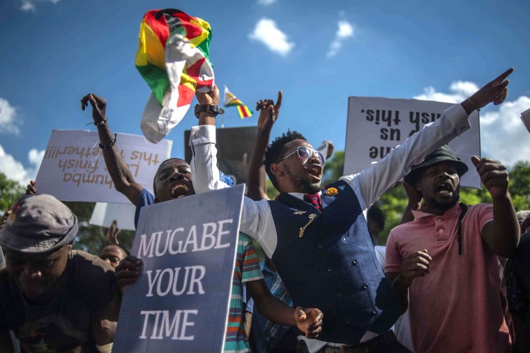 Image:People shout as they gather at Unity square opposite to the Parliament