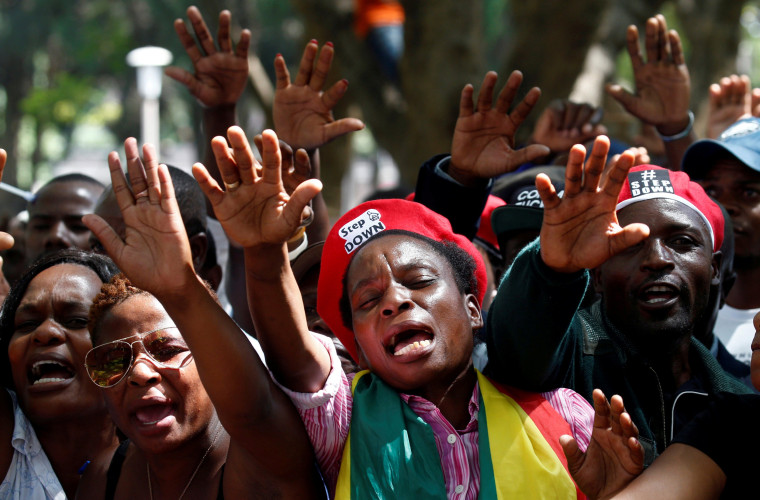 Image: Protesters calling for Zimbabwean President Robert Mugabe to resign attend a prayer meeting outside parliament in Harare