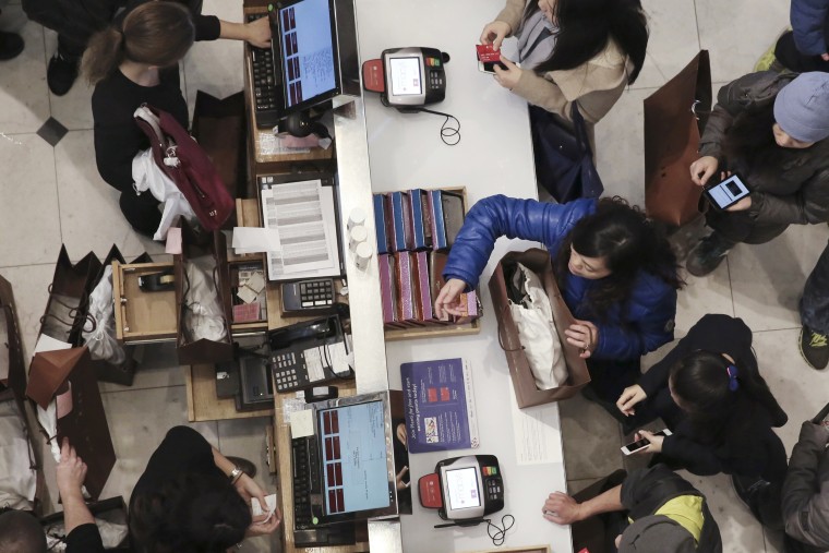 Image: Staff work the registers at Macy's Herald Square store during the early opening of the Black Friday sales